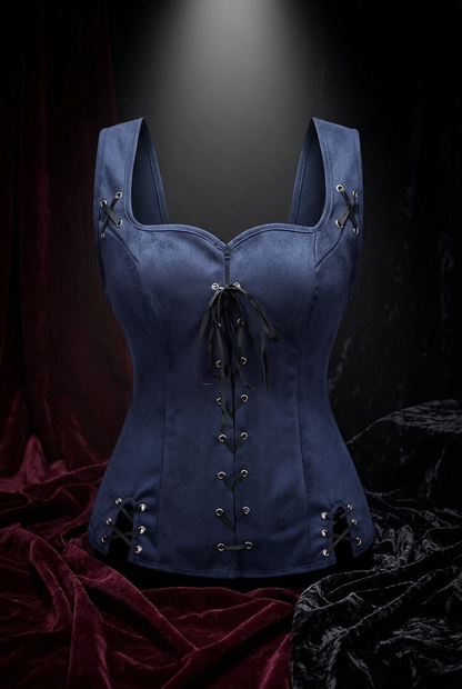 A navy blue suede lace-up corset top with silver grommets and black ribbon lacing, ghost mannequin display, dark burgundy velvet background with dramatic spotlight, gothic fashion editorial.