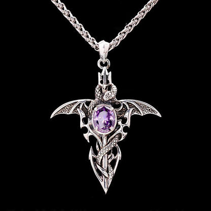 Dragon bat wing pendant necklace with purple amethyst gemstone displayed in open black velvet gift box, styled in candlelit gothic interior with ornate gold frame in background — Shadow Realm Supply