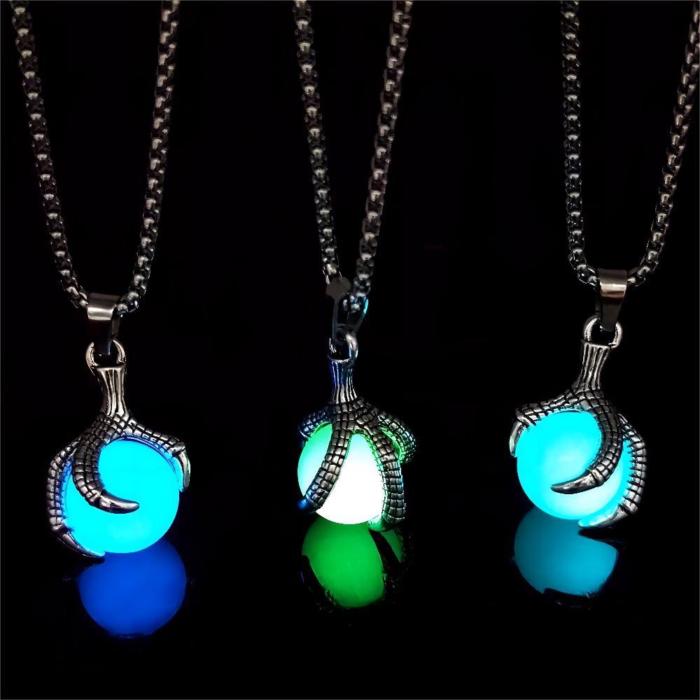 Glow in the dark dragon claw pendant necklace set showing blue, green, and teal glowing orb variants on silver box chain, displayed on black background — gothic alt fashion jewelry — Shadow Realm Supply