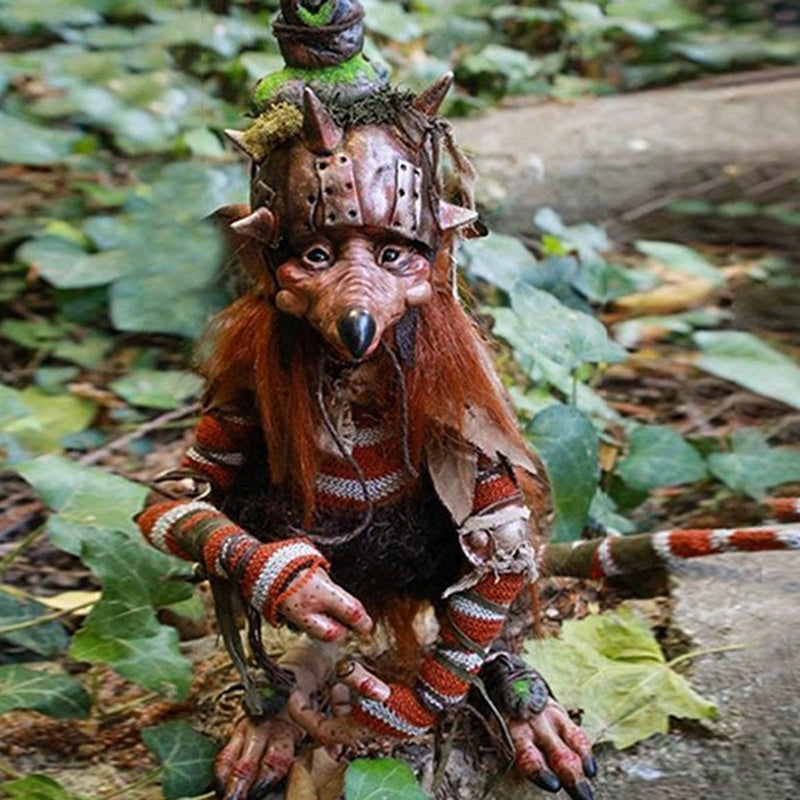 Gothic warrior rat goblin sculpture in spiked armor and striped knit crouching in ivy