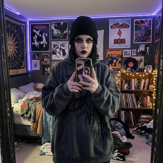 Alt goth model wearing oversized dark gray Harajuku graffiti drip text hoodie with black beanie, black nails and rings, mirror selfie in alt aesthetic bedroom with band posters and vinyl records — dark aesthetic streetwear hoodie — Shadow Realm Supply